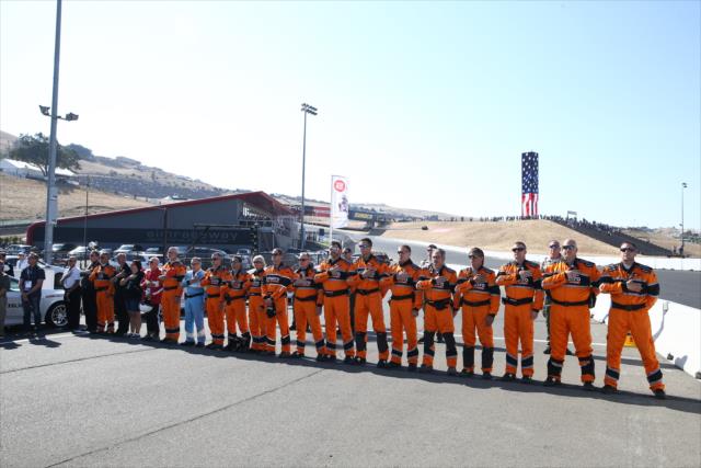 The Holmatro Safety Team line up on pit lane during pre-race introductions for the GoPro Grand Prix of Sonoma -- Photo by: Chris Jones