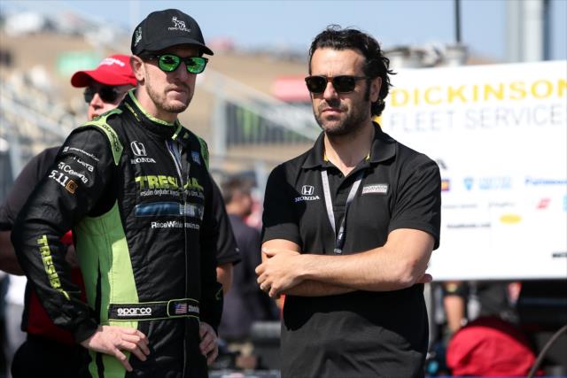 Charlie Kimball and Dario Franchitti chat along pit lane prior to the final warmup for the GoPro Grand Prix of Sonoma at Sonoma Raceway -- Photo by: Joe Skibinski