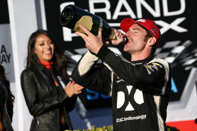 Simon Pagenaud with a celebratory slug of champagne in Victory Lane after winning the GoPro Grand Prix of Sonoma at Sonoma Raceway -- Photo by: Joe Skibinski