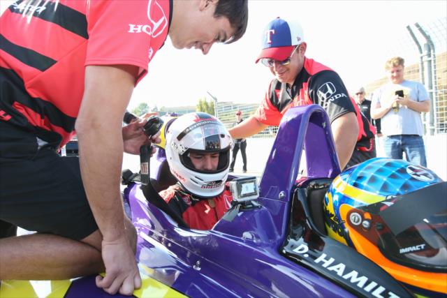Golden State Warriors star Klay Thompson gets strapped in prior to his two-seater ride around Sonoma Raceway -- Photo by: Joe Skibinski