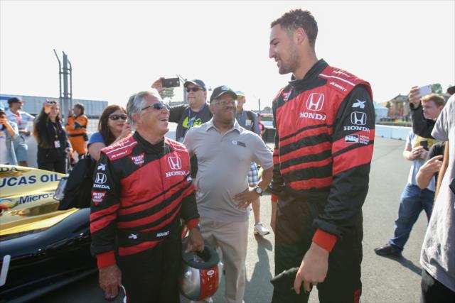 Golden State Warriors star Klay Thompson chats with Indy car legend Mario Andretti prior to his two-seater ride around Sonoma Raceway -- Photo by: Joe Skibinski
