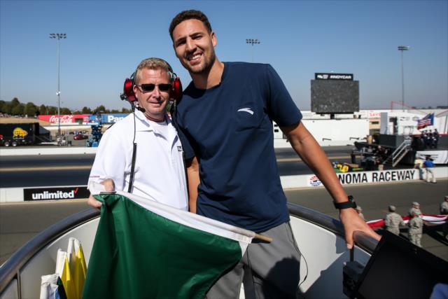 Golden State Warriors guard Klay Thompson gets ready to waive the green flag to start the GoPro Grand Prix of Sonoma -- Photo by: Joe Skibinski
