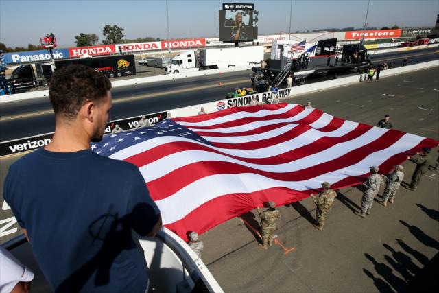 Klay Thompson overlooks the American flag during pre-race festivities for the GoPro Grand Prix of Sonoma -- Photo by: Joe Skibinski