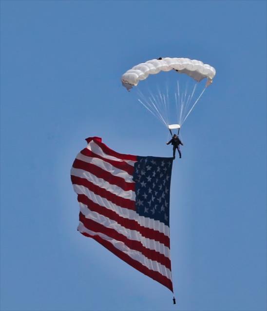 The American flag arrives via paratrooper during pre-race festivities for the GoPro Grand Prix of Sonoma at Sonoma Raceway -- Photo by: Richard Dowdy