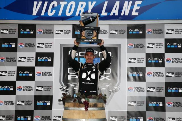 Simon Pagenaud hoists the winner's wine trophy in Victory Lane after winning the 2017 GoPro Grand Prix of Sonoma at Sonoma Raceway -- Photo by: Chris Jones