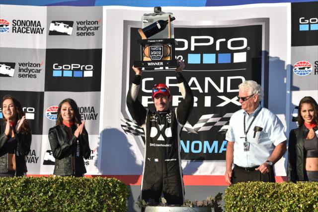 Simon Pagenaud hoists the winner's wine trophy in Victory Lane after winning the GoPro Grand Prix of Sonoma at Sonoma Raceway -- Photo by: Chris Owens