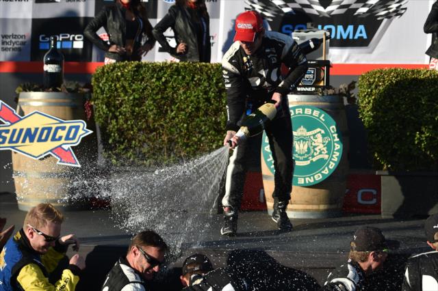 Simon Pagenaud sprays the champagne in Victory Circle after winning the GoPro Grand Prix of Sonoma at Sonoma Raceway -- Photo by: Chris Owens