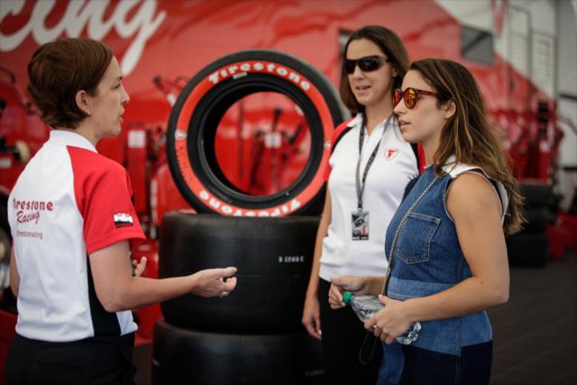 Olympic gymnast Aly Raisman chats with Firestone Director of Motorsports Lisa Boggs (L) and Chief Engineer Cara Adams (C) in the Firestone garages at Sonoma Raceway -- Photo by: Shawn Gritzmacher
