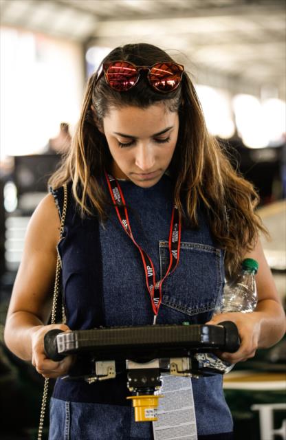 Olympic gymnast Aly Raisman and looks over the steering wheel of Spencer Pigot in the Ed Carpenter Racing garages at Sonoma Raceway -- Photo by: Shawn Gritzmacher