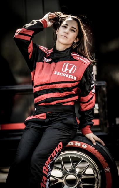 Olympic gymnast Aly Raisman poses with a Firestone tire prior to her two-seater ride at Sonoma Raceway -- Photo by: Shawn Gritzmacher