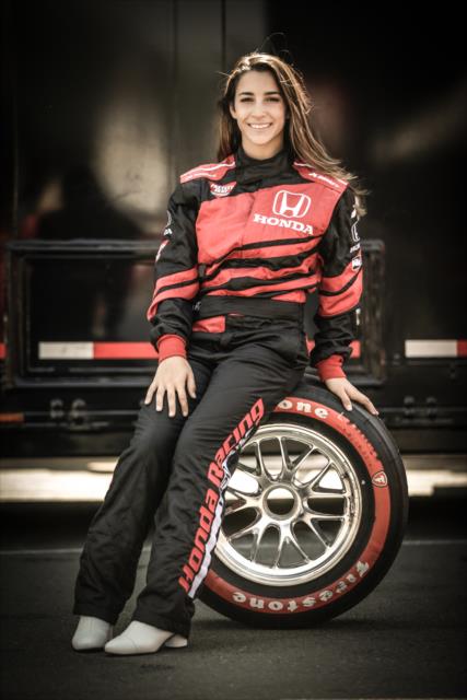 Olympic gymnast Aly Raisman poses with a Firestone tire prior to her two-seater ride at Sonoma Raceway -- Photo by: Shawn Gritzmacher