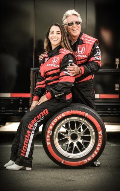 Olympic gymnast Aly Raisman poses with Indy car legend Mario Andretti prior to her two-seater ride at Sonoma Raceway -- Photo by: Shawn Gritzmacher