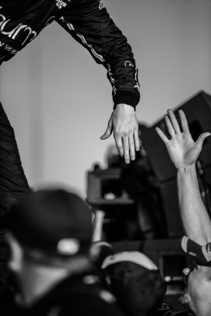 Josef Newgarden gives his Team Penske crew high-fives on the Championship stage after winning the 2017 Verizon IndyCar Series championship -- Photo by: Shawn Gritzmacher