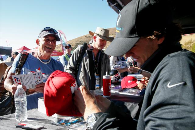Colton Herta signs an autograph for a fan during the autograph session in the INDYCAR Fan Village at Sonoma Raceway -- Photo by: Joe Skibinski