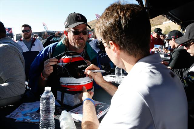 Will Power signs a helmet for a fan during the autograph session in the INDYCAR Fan Village at Sonoma Raceway -- Photo by: Joe Skibinski