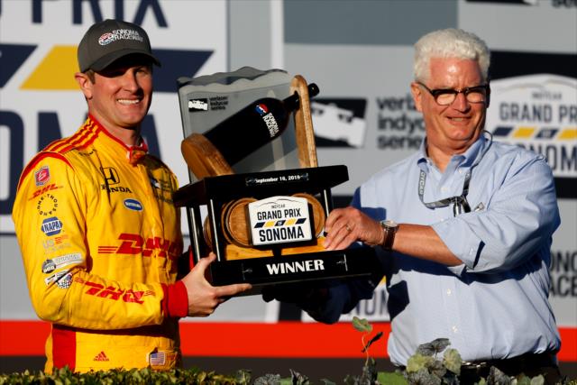Ryan Hunter-Reay is presented the winner's trophy in Victory Lane by Sonoma Raceway President Steve Page after winning the INDYCAR Grand Prix of Sonoma -- Photo by: Joe Skibinski