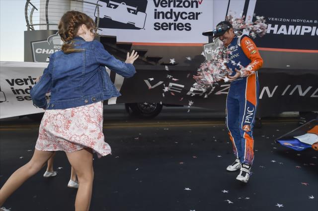 Scott Dixon's daughters, Poppy & Tilly, throw confetti at their father during the championship celebration at Sonoma Raceway -- Photo by: Chris Owens