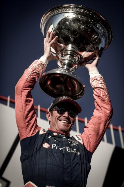 Scott Dixon hoists the Astor Cup on stage after winning the 2018 Verizon IndyCar Series championship at Sonoma Raceway -- Photo by: Shawn Gritzmacher