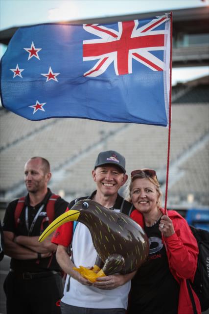 Fans fly the New Zealand flag and sport a kiwi statue during the championship celebration at Sonoma Raceway -- Photo by: Shawn Gritzmacher