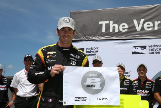 Simon Pagenaud with the Verizon P1 Award flag for winning the pole position for the Iowa Corn 300 at Iowa Speedway -- Photo by: Chris Jones