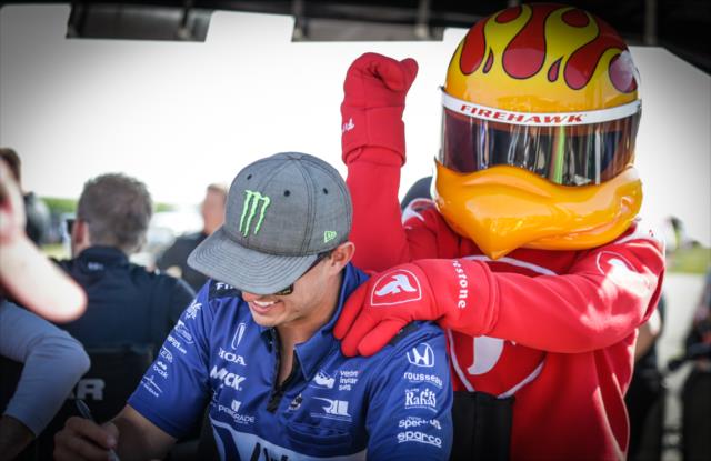 The Firestone Firehawk gives Graham Rahal a massage during the driver autograph session in the Iowa Speedway Fan Village -- Photo by: Shawn Gritzmacher