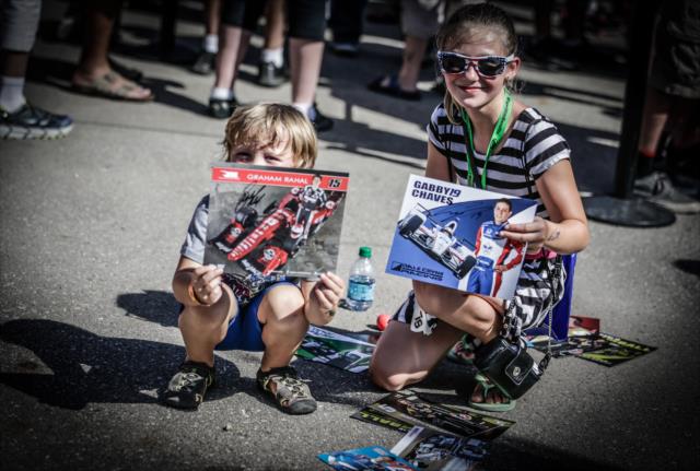 Young fans cherishing their new autographed hero cards during the autograph session at the Iowa Speedway Fan Village -- Photo by: Shawn Gritzmacher