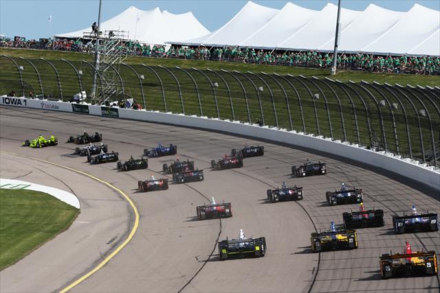 The field streams into Turn 1 at the start of the Iowa Corn 300 at Iowa Speedway -- Photo by: Chris Jones