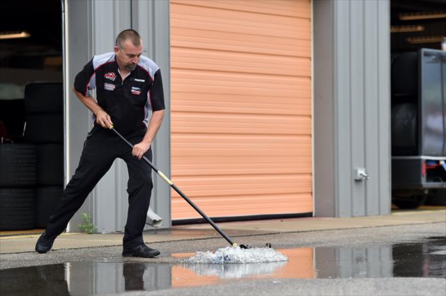 Andretti Autosport crewman sweeps away rain puddles following a shower at Iowa Speedway prior to the Iowa Corn 300 -- Photo by: Chris Owens