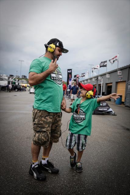 A young fan and his father walk the Iowa Speedway paddock area prior to the Iowa Corn 300 -- Photo by: Shawn Gritzmacher
