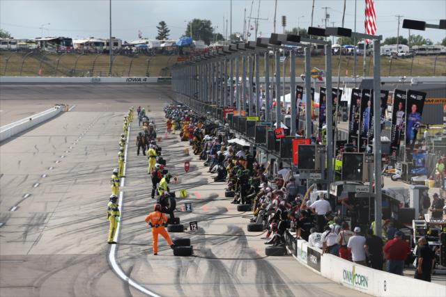 Crews wait for their drivers along pit lane during an early caution period at the Iowa Corn 300 -- Photo by: Chris Jones