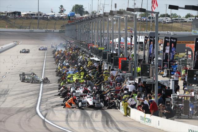 Pit lane comes to life for pit stops during the Iowa Corn 300 at Iowa Speedway -- Photo by: Chris Jones
