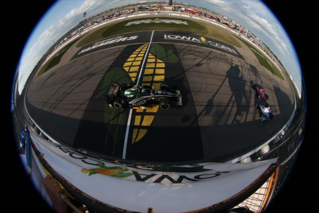 JR Hildebrand streaks across the start/finish line during the Iowa Corn 300 at Iowa Speedway -- Photo by: Chris Jones
