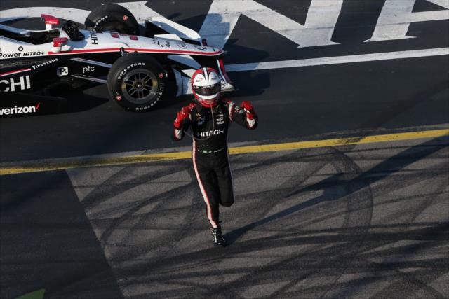 Helio Castroneves runs toward the frontstretch fence after winning the Iowa Corn 300 at Iowa Speedway -- Photo by: Chris Jones