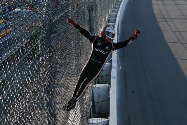 Helio Castroneves celebrates with a fence climb after winning the Iowa Corn 300 at Iowa Speedway -- Photo by: Chris Jones