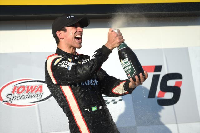 Helio Castroneves sprays the champagne in Victory Circle after winning the 2017 Iowa Corn 300 at Iowa Speedway -- Photo by: Chris Owens