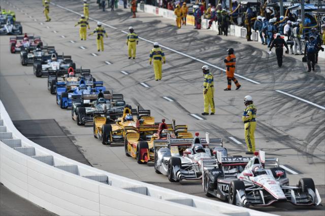 Helio Castroneves leads the field onto pit lane for the mid-race red flag for moisture during the Iowa Corn 300 at Iowa Speedway -- Photo by: Chris Owens