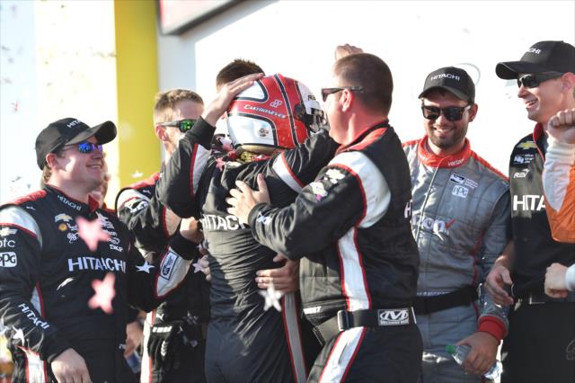 Helio Castroneves is mobbed by is Team Penske crew in Victory Circle after winning the Iowa Corn 300 at Iowa Speedway -- Photo by: Chris Owens
