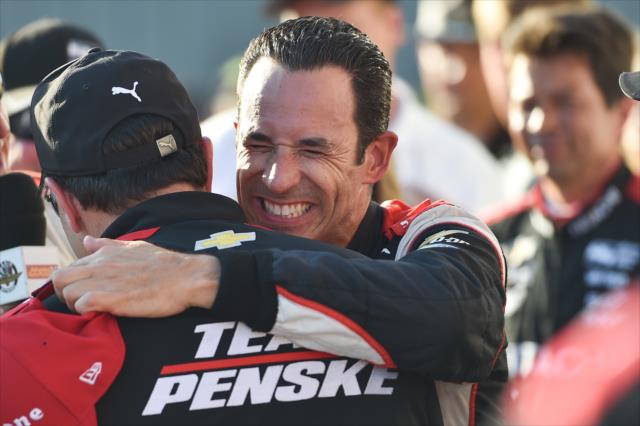 Helio Castroneves gets hugs from his Team Penske crew in Victory Circle after winning the Iowa Corn 300 at Iowa Speedway -- Photo by: Chris Owens