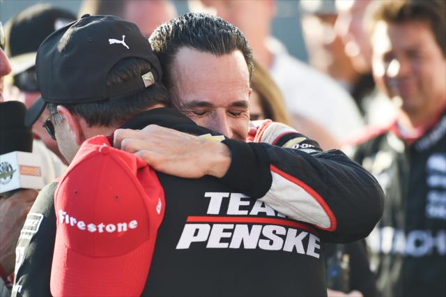 Helio Castroneves gets a well-deserved embrace from his Team Penske crew in Victory Circle after winning the Iowa Corn 300 at Iowa Speedway -- Photo by: Chris Owens