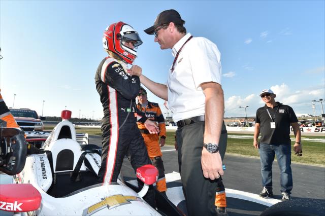 Helio Castroneves is congratulated by Team Penske President Tim Cindric on the frontstretch after winning the Iowa Corn 300 at Iowa Speedway -- Photo by: Chris Owens
