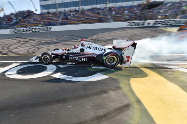 Helio Castroneves with a smoky burnout on the frontstretch after winning the Iowa Corn 300 at Iowa Speedway -- Photo by: Chris Owens