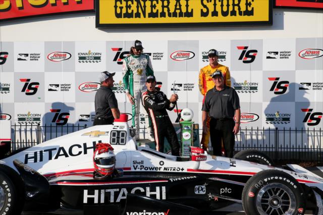 Helio Castroneves celebrates with the winning trophy in Victory Circle after winning the Iowa Corn 300 at Iowa Speedway -- Photo by: Joe Skibinski
