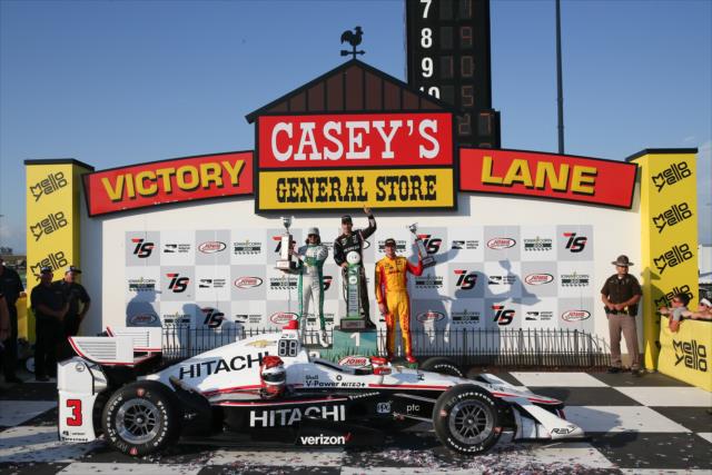 The podium of Helio Castroneves, JR Hildebrand, and Ryan Hunter-Reay hoist their trophies in Victory Circle following the Iowa Corn 300 -- Photo by: Joe Skibinski