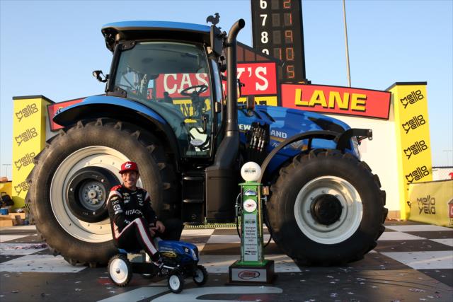 Helio Castroneves aboard a mini-tractor in Victory Circle after winning the Iowa Corn 300 at Iowa Speedway -- Photo by: Joe Skibinski