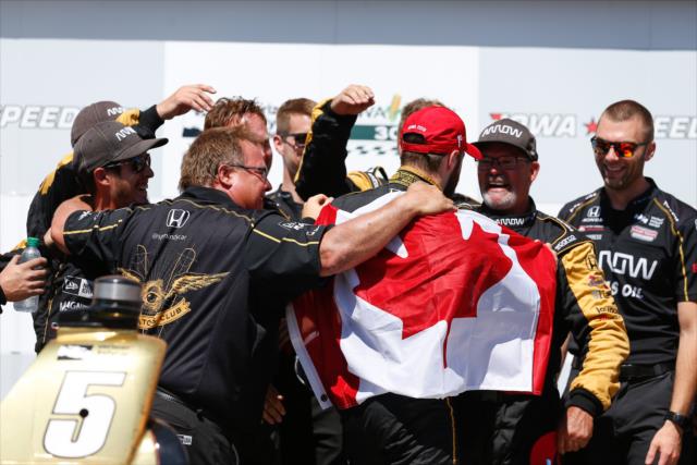 James Hinchcliffe celebrates with this Schmidt Peterson Motorsports crew in Victor Circle after winning the Iowa Corn 300 at Iowa Speedway -- Photo by: Joe Skibinski