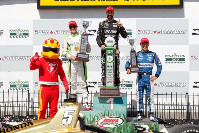 The podium of James Hinchcliffe, Spencer Pigot, and Takuma Sato with their trophies and the Firestone Firehawk in Victory Lane following the Iowa Corn 300 at Iowa Speedway -- Photo by: Joe Skibinski