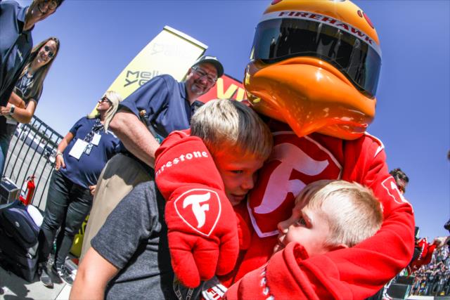 The Firestone Firehawk gives a few young fans a hug in Victory Circle following the Iowa Corn 300 at Iowa Speedway -- Photo by: Shawn Gritzmacher