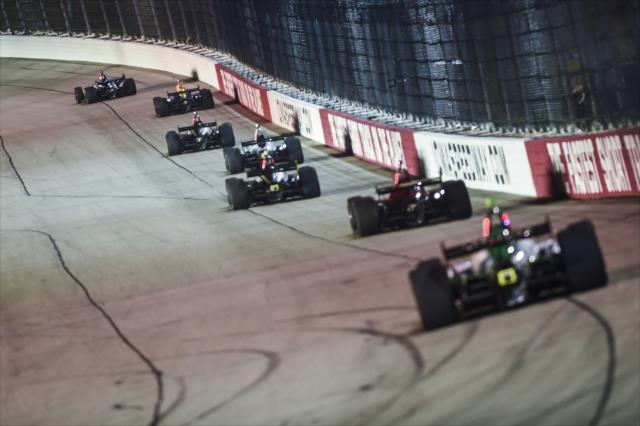 A line of cars screaming down the backstretch -- Photo by: Chris Owens