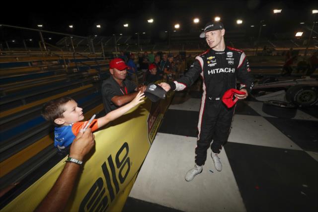 Josef Newgarden handing out a hat to a fan after winning the Iowa 300 -- Photo by: Chris Owens
