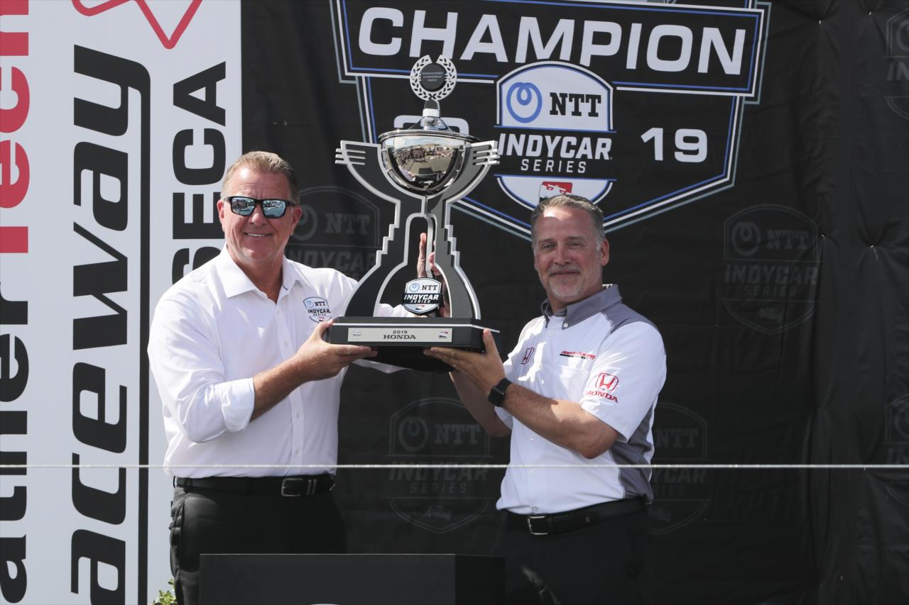 Jay Frye, INDYCAR president, presents the manufacturer championship trophy to Ted Klaus, president of Honda Performance Development  -- Photo by: Chris Owens